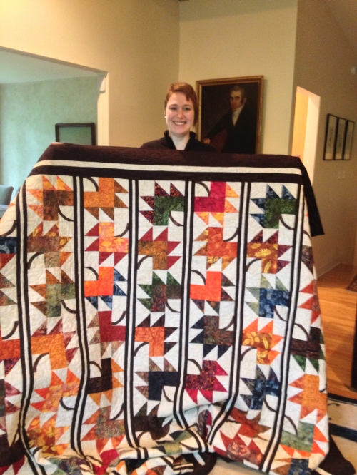 Lindsey shows off her finished quilt - which she just finished binding.